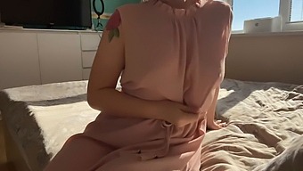 A Woman In A Feminine Pink Dress Explores Her Intimate Areas